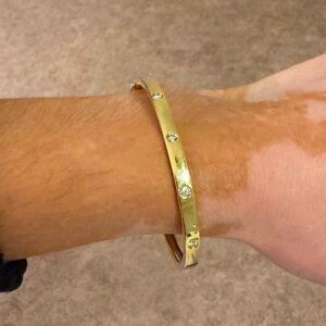 14 carat gold diamond bangle bracelet. Normal wear and tear. Shy Collection